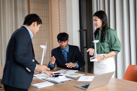 ESG Initiative Discussion. Professionals strategizing on sustainable practices in a modern...