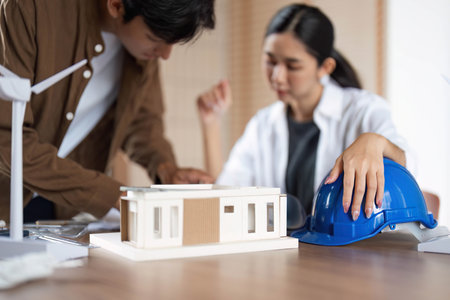 ESG Focused Design. Young professionals strategizing sustainable architecture solutions.の写真素材