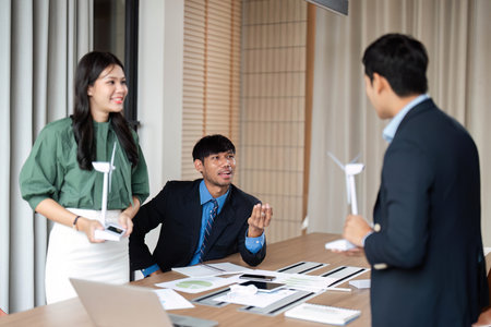 ESG Collaboration. Team members presenting sustainable solutions in a corporate meeting.の写真素材