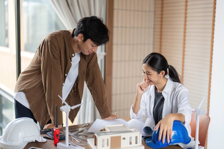 ESG Focused Collaboration. Young professionals working on sustainable architecture projects.の写真素材