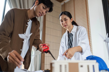 ESG Focused Teamwork. Architects collaborating on a sustainable model project.の写真素材