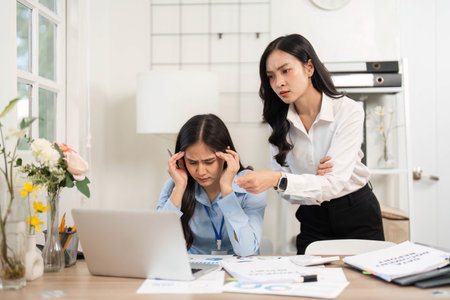 Stressful Work Situation. Businesswoman supporting her colleague during a challenging moment in the office.の写真素材