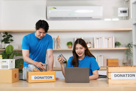 Donation organization by young volunteers in a collaborative workspaceの写真素材