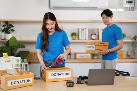 Volunteers packing donation boxes for community outreachの写真素材