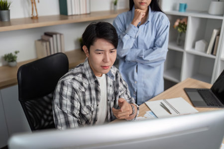 UX and UI Teamwork. Young professionals analyzing designs on computer screen.の写真素材