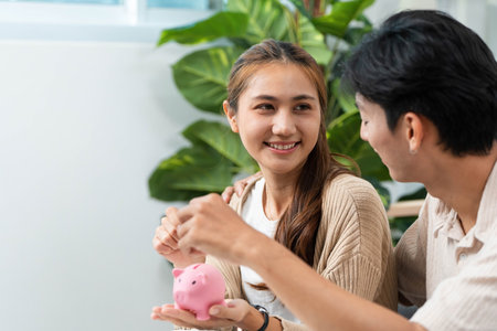 Couple Collaborating on Financial Goals. Engaging in budgeting with a piggy bank and calculator.の写真素材