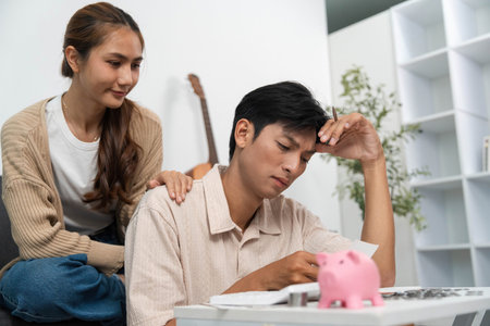 Financial Awareness. Couple discussing expenses while managing finances at home.の写真素材