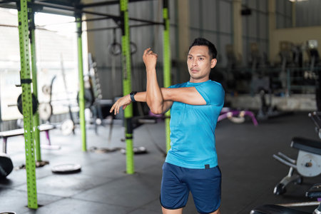 Fitness Stretching: Man Preparing for Workout in Gym