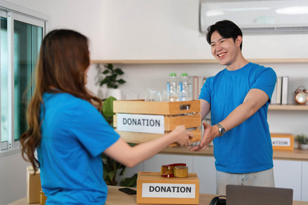 Donation Activity. Volunteers engaging in charitable giving with donation boxes.の写真素材