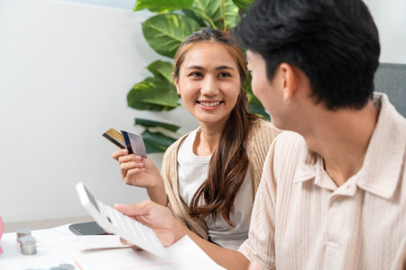 Financial Planning and Budgeting. Couple discussing expenses and managing finances at home.