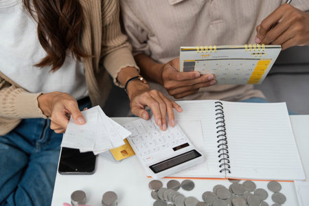 Couple Budgeting Together. Young partners managing finances with calculator and notes.の写真素材