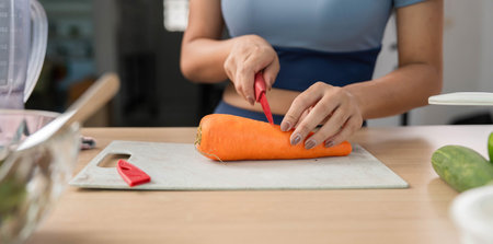 Sustainable Cooking. Woman preparing fresh carrots in a modern kitchen for healthy meals.