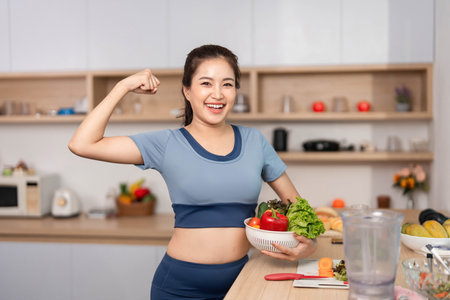 ESG and Empowerment. Confident woman flexing her muscles while holding fresh produce.の写真素材