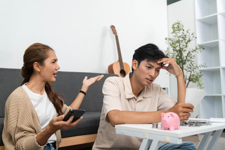 Financial Stress and Communication. Couple discussing financial issues at home.の写真素材