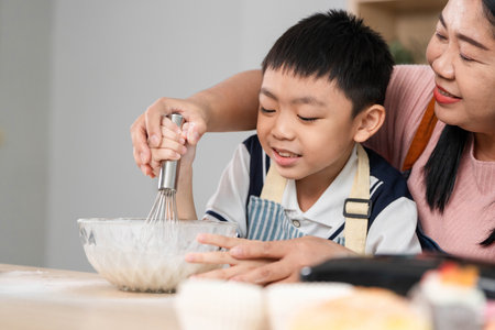 Family Cooking Together. A mother and son enjoying a fun baking session in the kitchen.の写真素材