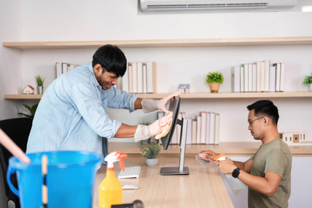 Teamwork in Office Cleaning. Two men collaborating on workspace maintenance.