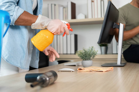 Cleaning and Organization. Two friends tidying up a modern living space with a rainbow flag.の写真素材