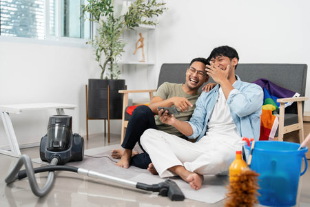 Joyful LGBTQIA Couple Enjoying House Cleaning Togetherの写真素材