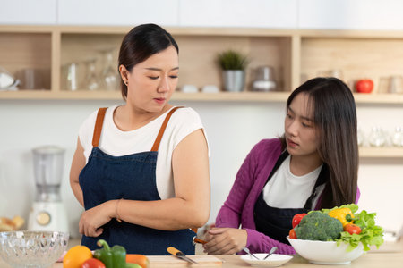 Cooking Together: Two Women Preparing Healthy Meals in Modern Kitchenの写真素材