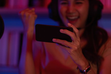 Close-Up of Happy Gamer Celebrating with Smartphone