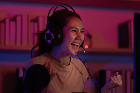 Joyful Gamer Reacting to Game Success with Headset