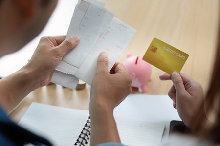 Expense Tracking and Financial Decisions. Couple analyzing receipts and credit card.