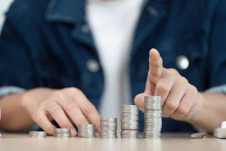 Financial Planning and Savings. Individual counting coins for budgeting and investment.の写真素材