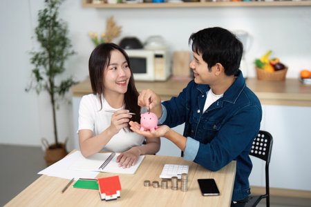 Couple Engaging in Savings Discussion. Young adults planning finances with a piggy bank.の写真素材