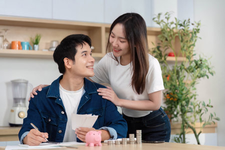 Couple Discussing Financial Goals. Young partners reviewing savings and budgeting together.の写真素材