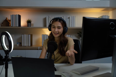 Digital Content Creation. Young woman in headphones animatedly discussing with her audience.