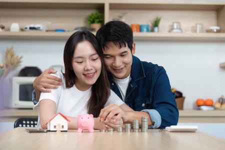 Couple Planning Future Together. Young partners celebrating financial milestones with savings.の写真素材