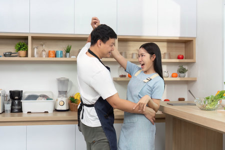 Couple Dancing in Kitchen. Celebrating love and joy through movement.