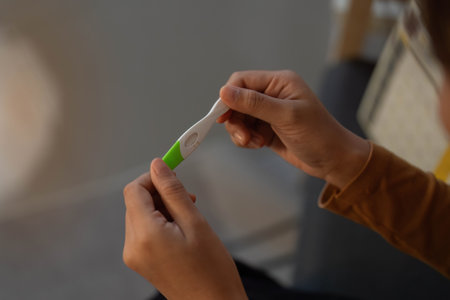 Pregnancy Test. Woman examining results with focus.