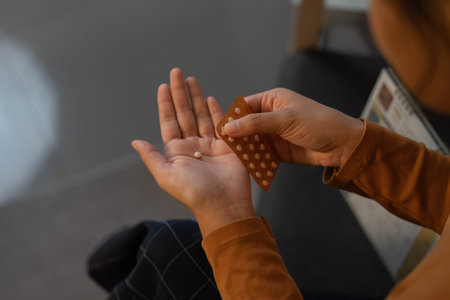 Health Monitoring. Woman taking medication for wellness and self-care.の写真素材