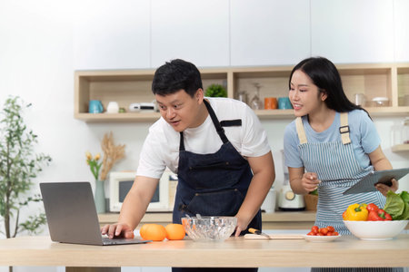 Cooking Class: Couple Learning Recipes on Laptop in Kitchen