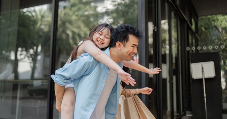 Joyful Family Enjoying a Holiday Shopping Adventure with Happy Parents and Excited Children in a...