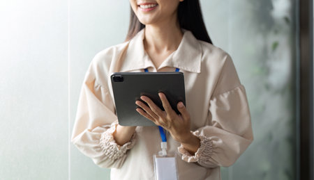 Dynamic businesswomen engaging with in a office environment optimizing work efficiencyの写真素材