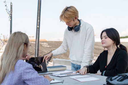High School Students Collaborate on Homework and Projects in a Relaxed Outdoor Setting After School Hoursの写真素材