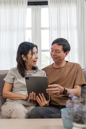 Retired Couple Enjoying a Relaxing and Comfortable Lifestyle in Their Cozy Living Room with Modern...