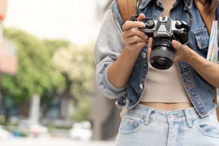 Photography Passion. Young woman holding camera ready to capture moments.の写真素材