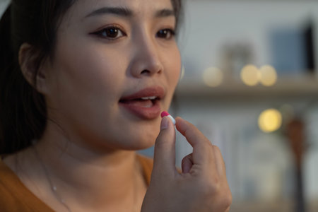 Health Awareness. Woman preparing to take medication, focusing on wellness.の写真素材