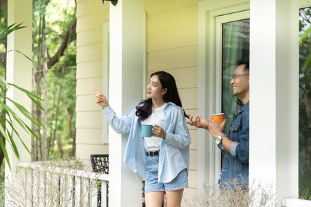 Exploring nature. Young couple enjoying a scenic view from their porch.の写真素材