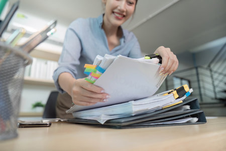Office Worker Organizing Documents with Colorful Tabs