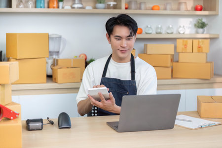 E-commerce professional managing orders with tablet and laptop in a home office
