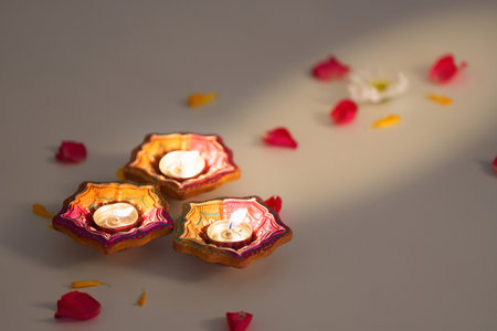 Diwali candle arrangement with vibrant marigold flowers and petalsの写真素材