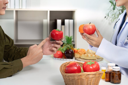 Food Comparison. Doctor discussing healthy versus unhealthy food choices with patient.