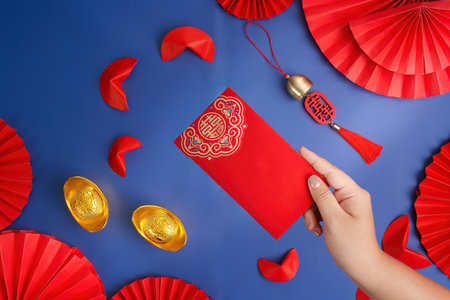 Lunar New Year red envelope and gold ingots on blue backgroundの写真素材