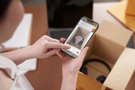 Taking a photo of new headphones in a packageの写真素材