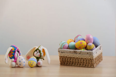 Easter Fun. Two bunnies with colorful eggs in a woven basket.