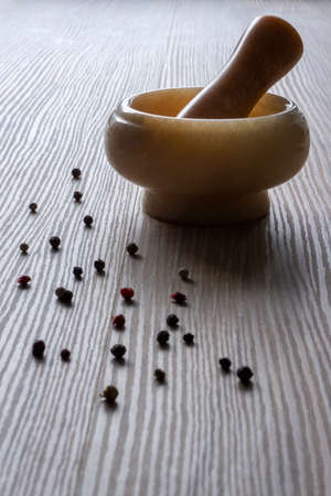 pounder and pepper mix on wooden tableの写真素材